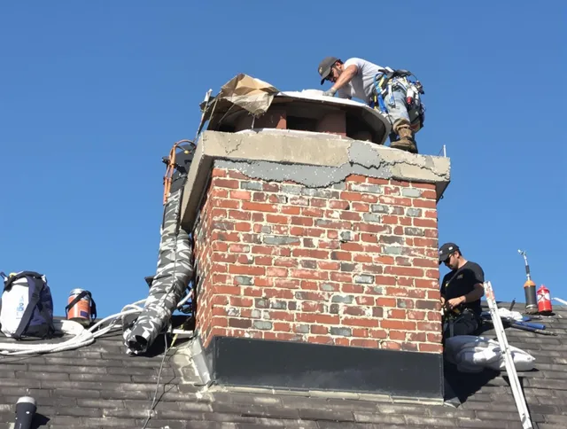 Redlands Chimney Sweep installing a custom chimney crown in Redlands, CA